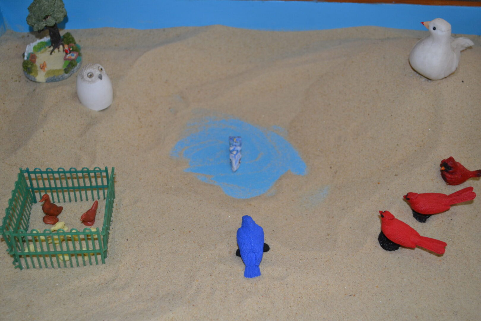 A group of people standing in the sand.